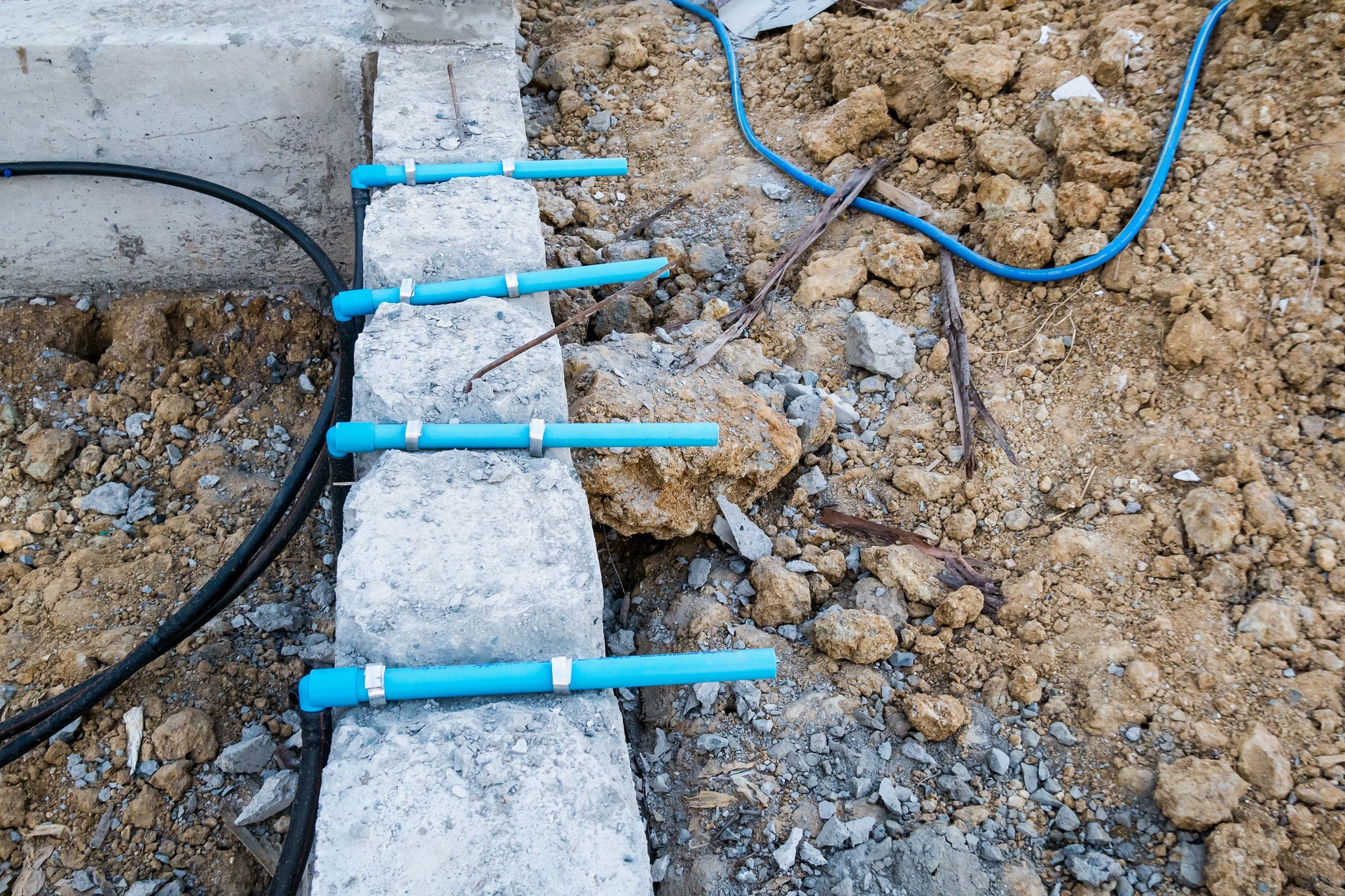 Pest control pipe system install at new house construction foundation for termite protection