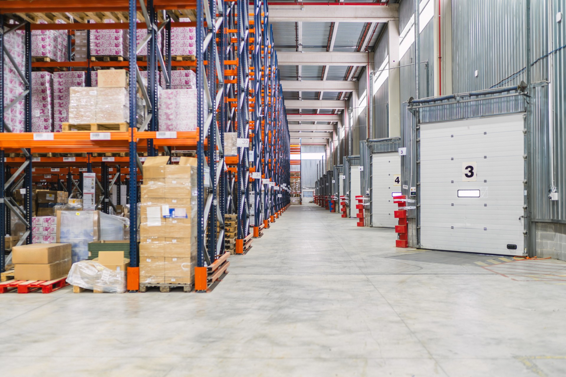 Logistics warehouse storing goods on metal shelves